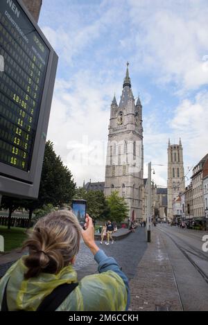Ghent, Flemish Region-Belgium. 22-08-2021. Tourist walks in the old town. Taking photos of landmarks on a smartphone Stock Photo