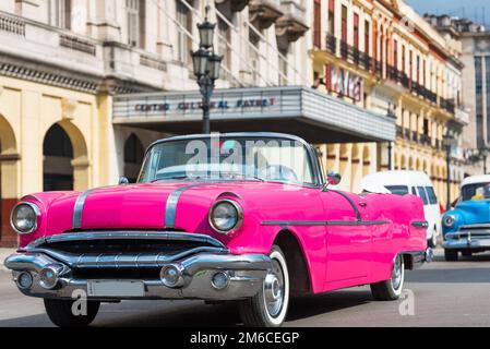 American pink convertible classic car drive with tourists through Havana Cuba - Serie Cuba R Stock Photo