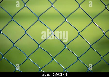 Mesh fence on vernacular background. Fence details. Stock Photo