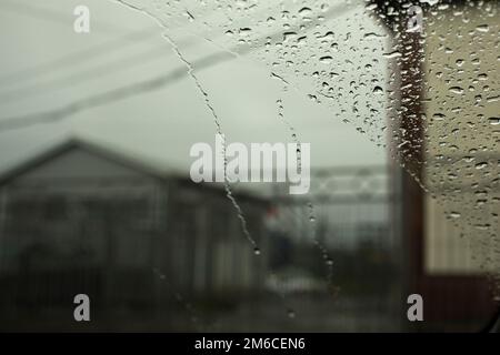 Raindrops on glass. Rainy weather outside window. Stock Photo