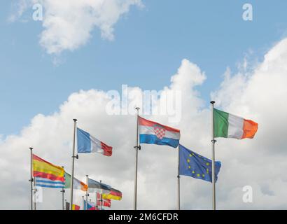 Brussels, Brussels-Capital Region, Belgium 20-08-2021. A number of flags of the European Union on a background of blue sky and clouds Stock Photo