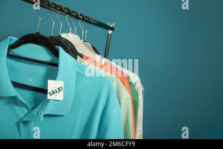 Clothes for sale are hanging on a hanger. Men's T-shirts, Women's Blouses XXL size Stock Photo