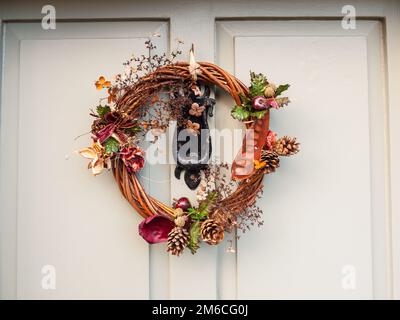 Beautiful christmas wreath on front of door hanging close up Stock Photo