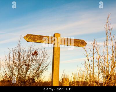 Stone sign post public footpath walking sign close up field nature outside Stock Photo