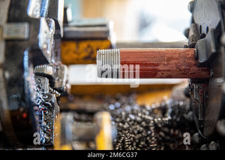 iron pipe beveling machine. Technician is Grooved Steel pipe. Fire fighting pipe groove Install sprinkler system. Worker cutting iron bars. Stock Photo
