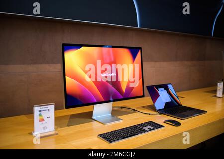 Paris, France - Oct 28, 2022: new Apple Computers MacBook Pro connected to the Studio Display 5k Retina monitor Stock Photo