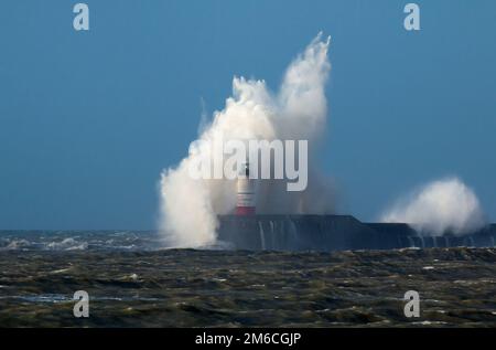 Waves over Lighthouse Stock Photo