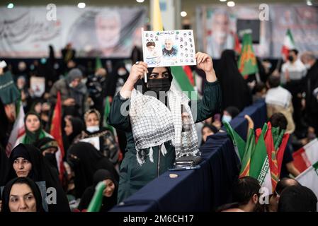Tehran, Iran. 03rd Jan, 2023. A mourner holds a poster of the late Revolutionary Guard Gen. Qassem Soleimani, who was killed in Iraq in a U.S. drone attack in 2020, during a ceremony marking the anniversary of his death, at Imam Khomeini Grand Mosque in Tehran, Iran, Tuesday, Jan. 3, 2023. (Photo by Sobhan Farajvan/Pacific Press) Credit: Pacific Press Media Production Corp./Alamy Live News Stock Photo