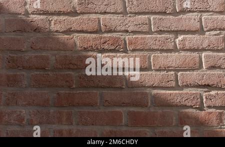 Direct diagonal sun shadow on brick wall texture Stock Photo