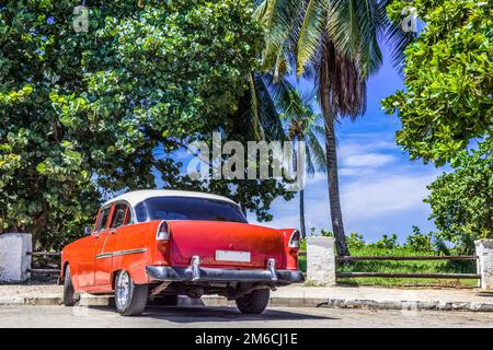 HDR - American red vintage car with white roof parked on the beach in Varadero Cuba - Serie Cuba Rep Stock Photo
