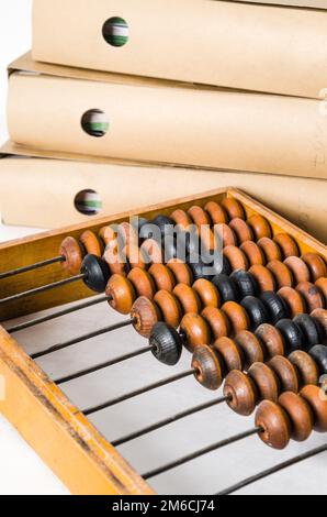 Old abacus and folders with documents, close-up isolated on white Stock Photo