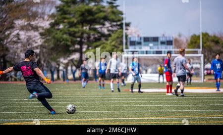 Participants from Team Misawa play soccer during the first-ever Sakura Olympics at Misawa Air Base, Japan, April 22, 2022. The event ended in a ceremony in which Japan Air Self-Defense Force and U.S. Air Force leadership recognized participants from all the sports as well as the hard work put into making the event happen. Stock Photo