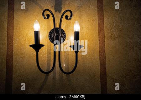 Decorative electric pendant on the wall. Stock Photo