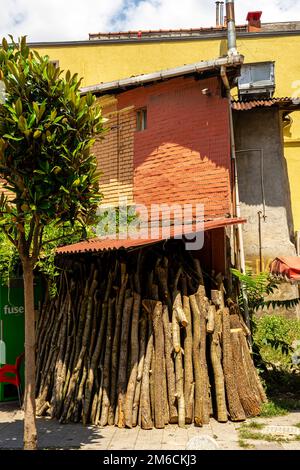 Wood logs in stack beside delapidated shabby house in Kadikoy, Istanbul Stock Photo