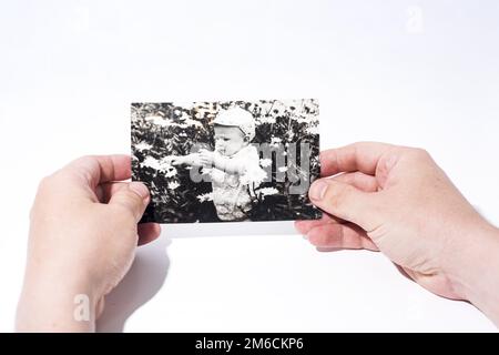 Old paper photo in mans hands. Stock Photo