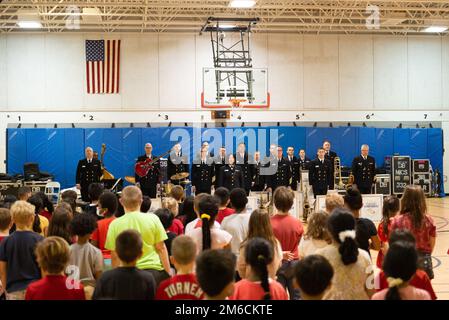 220422-N-SJ665-1004 SPRINGFIELD, Va. (April 22, 2022) Students at Cardinal Forest Elementary School stand for the singing of the National Anthem by Musician 1st Class Kristine Hsia.  The United States Navy Band Commodores performed at the school as part of the Navy Band's Music in the Schools educational outreach program. Stock Photo