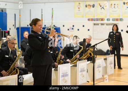 220422-N-SJ665-1020 SPRINGFIELD, Va. (April 22, 2022) Musician 1st Class Ally Albrecht plays a trumpet solo with the United States Navy Band Commodores during a Music in the Schools concert for students at Cardinal Forest Elementary School.  Music in the Schools is an educational outreach program developed by the Navy Band which reaches diverse audiences in the Washington, D.C. region. Stock Photo
