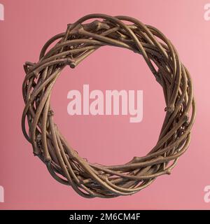 Christmas wreath on a pink background, made of twigs with gilding. Square format. Close-up, texture. Stock Photo