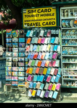Sim cards, phone covers, mobile phones stand stall, shop offering mobile devices and simcards, in various languages in Fatih, Istanbul Turkey Stock Photo