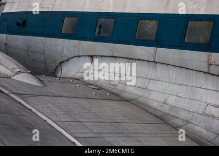 Background of wing and cabin of old metal plane. Stock Photo