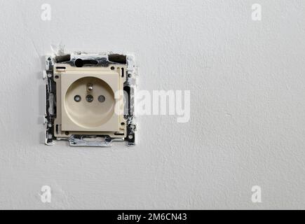 Framing cover from the socket. On the white wall Stock Photo