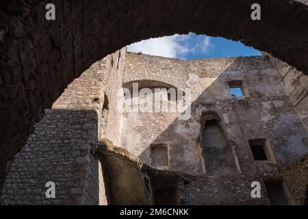 Low angle view of an old stone wall castle with blue sky background. Stock Photo