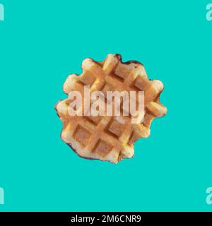 The texture of a standard waffle, on a light blue background. Square format Stock Photo