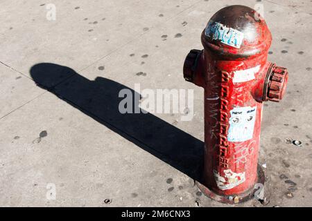 Street hydrant for water access in the street with shadow. Stock Photo