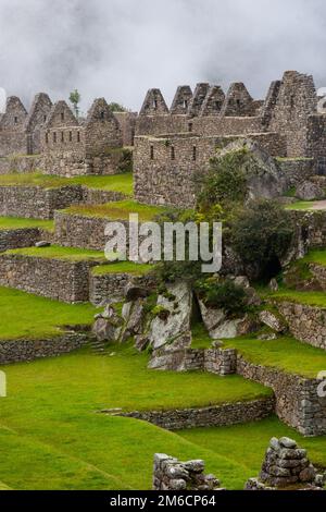 Machu Picchu ruins and green fields. Stock Photo