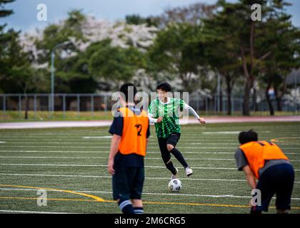 Participants from Team Misawa play soccer during the first-ever Sakura Olympics at Misawa Air Base, Japan, April 22, 2022. The Sakura Olympics gets its name from the famous cherry blossom tree. Throughout history, the Japanese government has given numerous cherry blossom trees to the U.S. government, symbolizing the bond between the two nations. Stock Photo