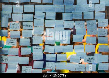 Blue note sticky notes on a glass wall. Stock Photo
