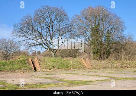 Remains of blast pen bunkers from the Second World War at Kenley Aerodrome or RAF Kenley on the southern border of London and Surrey, England, UK Stock Photo