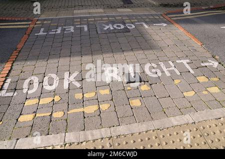 Detail of look right and look left road markings painted on a UK pedestrian road crossing Stock Photo