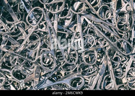 Basket full of steel nail scissors. Stock Photo