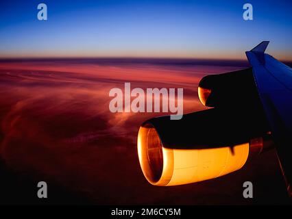 View of the sunset from the airplane porthole. Stock Photo