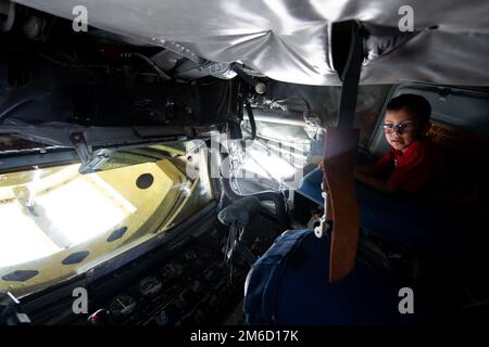 Ezra Oliveros inspects the boom-pod of a KC-135 Stratotanker from Altus AFB, Oklahoma at The Great Texas Airshow, Apr. 23, 2022, at Joint Base San Antonio-Randolph, Texas. The Great Texas Airshow, featuring the Thunderbirds, was April 23 thru 24 at JBSA-Randolph. The Thunderbirds perform for people all around the world to display the pride, precision and professionalism the U.S. Air Force represents. Through air shows and flyovers, they aim to excite and inspire. In addition to showcasing the elite skills all pilots must possess, the Thunderbirds demonstrate the incredible capabilities of the Stock Photo
