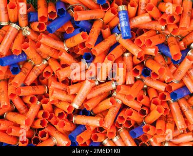 Background of many colorful shot empty shotgun shells Stock Photo