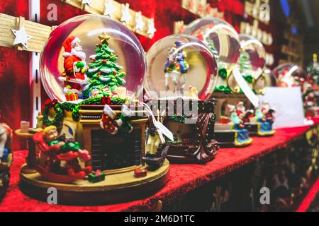 Christmas snow globe background crystal ball with santa claus and christmas tree inside Stock Photo