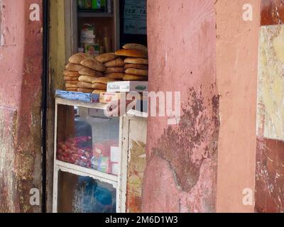 Marrakech, Morocco - March 30, 2012: Snack bar kiosk, with shopkeeper's hand outstretched Stock Photo