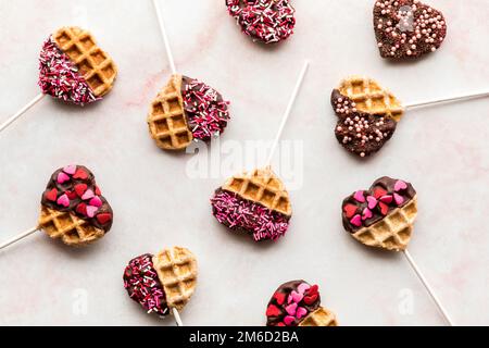 Top down view of decorated heart shaped waffle pops for Valentine's Day Stock Photo