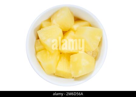 Pineapple slices fruits from above bowl isolated on white Stock Photo