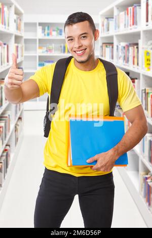 Student success successful thumbs up library learning portrait format smiling people Stock Photo