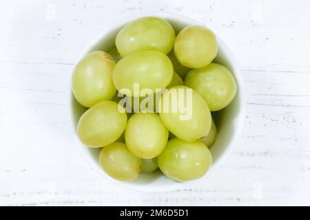 Grapes green fruits fruit from above bowl wooden board Stock Photo