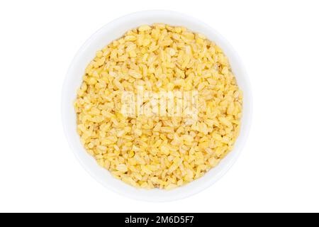 Bulgur wheat grain grains from above bowl isolated on white Stock Photo