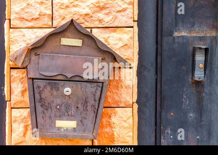 A beautiful mailbox hangs waiting for newspapers, parcels and letters. Stock Photo