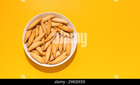 Top view of Spanish mini picos on yellow Stock Photo