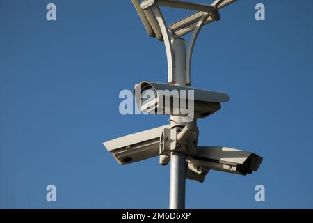 Security camera record live, Security camera on blue sky background. Stock Photo
