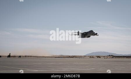 A United Arab Emirate C-17 Globemaster aircraft with 16th Airlift Squadron, UAE Air Force, departs from the Strategic Expeditionary Landing Field following an ammunition retrograde at Marine Corps Air Ground Combat Center, Twentynine Palms, California, Feb. 25, 2022. The U.S. Marine Corps and UAE maintain a close relationship through persistent bilateral training engagements and programs, enhancing each other’s ability to conduct counterterrorism operations, protect critical infrastructure, and support national defense. Stock Photo