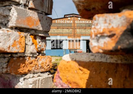 Gdansk, Poland - July 19 2022: Industrial building at the Gdansk Shipyard, former Lenin Shipyard, prefabrication workshop and heavy cranes large Polish shipyard. Cranes at historical shipyard in Gdansk headquarters of Solidarity Polska Stock Photo