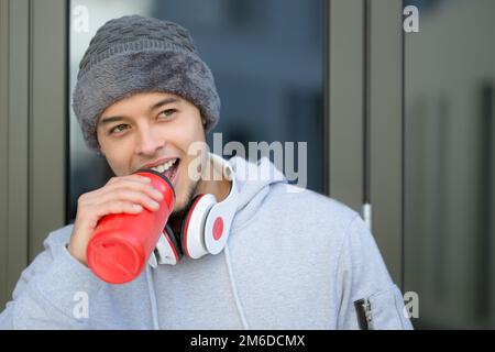 Smiling young latin man drinking water winter sports training fitness copyspace copy space Stock Photo